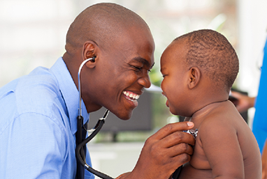 doctor with baby giggling 