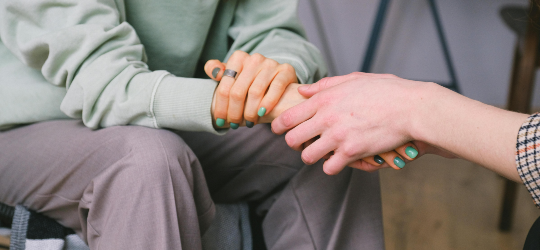 two people holding hands in embrace
