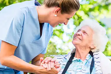 nurse holding hand of elderly patient