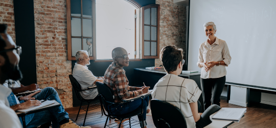 A classroom filled with adults in desks