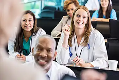 female doctor taking a class with other providers