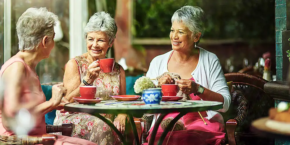 senior women knitting and enjoying tea