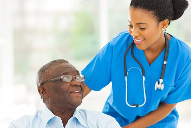 nurse standing and smiling with patient