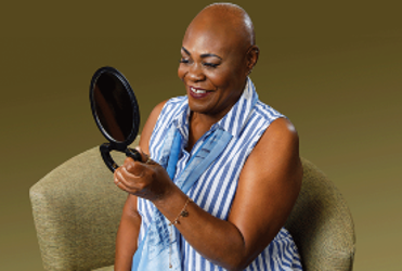 woman cancer patient holding up a mirror