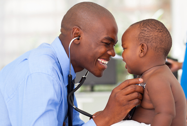 doctor holding stethoscope to baby's chest