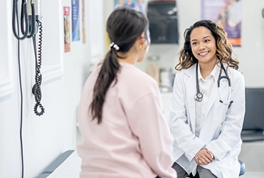 female patient facing female doctor
