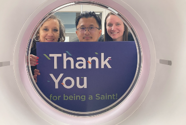 St. Anthony Hospital employees hold thank you sign for PET/CT